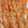 Carnelian flat twisted oval, 17 x 20mm. Sold per strand approx. 23 beads