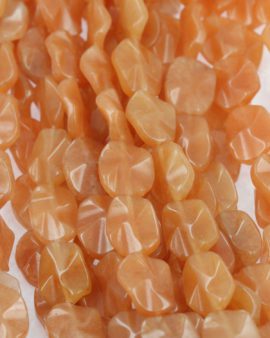 Carnelian flat twisted oval, 17 x 20mm. Sold per strand approx. 23 beads
