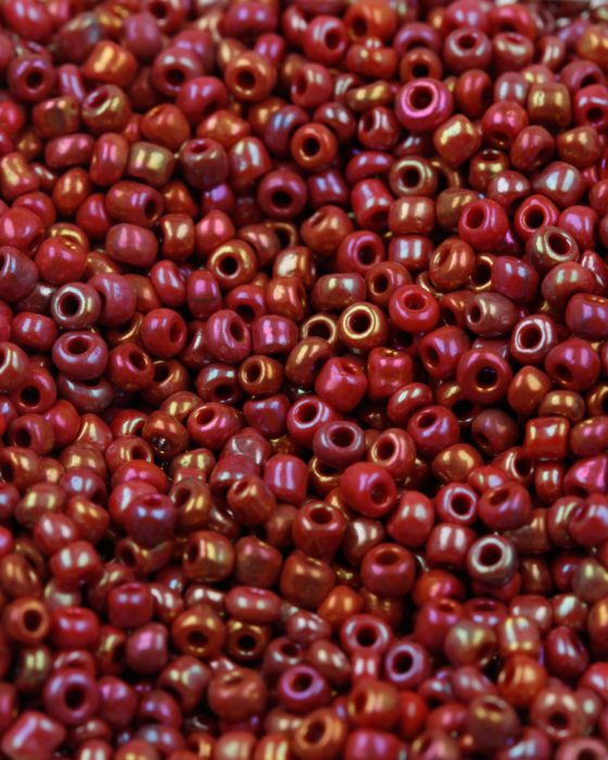 Opaque iridescent seed bead dark red