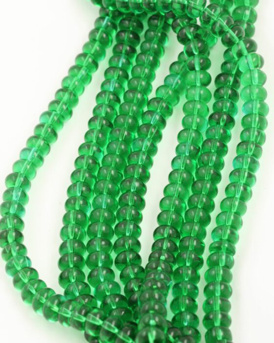 Disc Shape Glass Beads 7x11mm. Sold per strand approx 58 beads green transparent