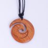 Carved wooden koru pendant